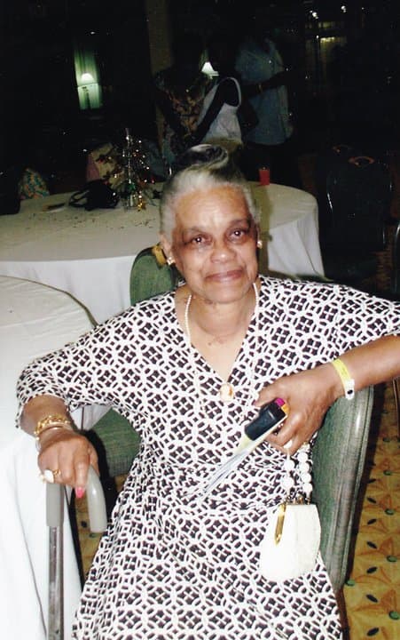 Merle seated with her handbag
