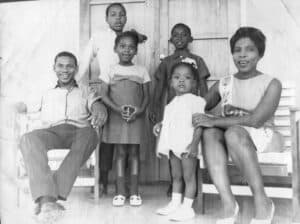 Fred and Jenny with children on the porch steps